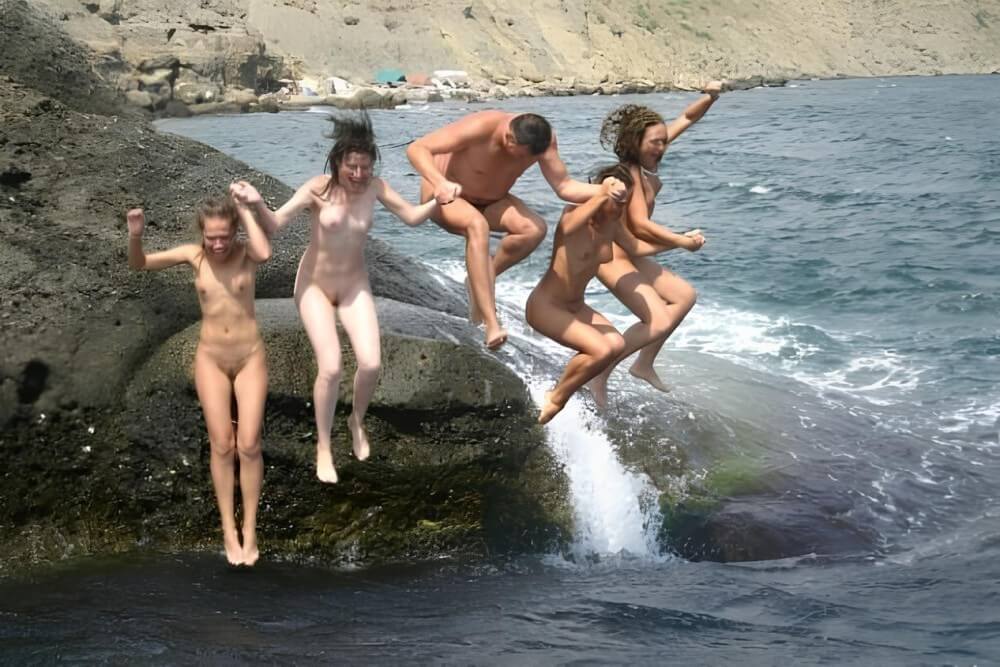 Mens and girls nudists on a beach - The culture of the free body
