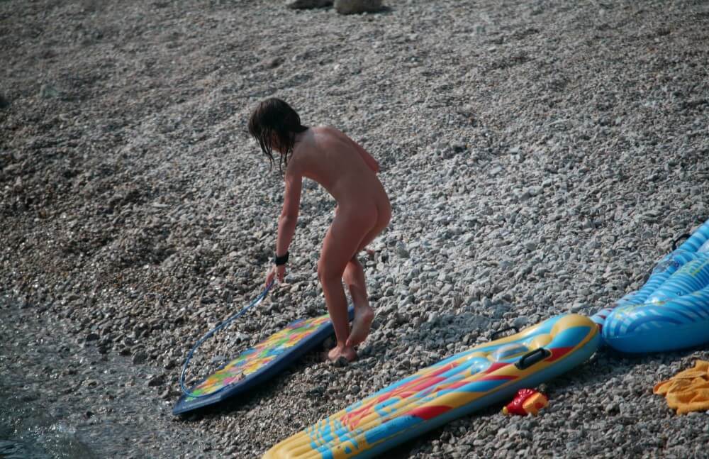 Naturist Surf Board Glides pics - Activities conducted in a state of complete nudity