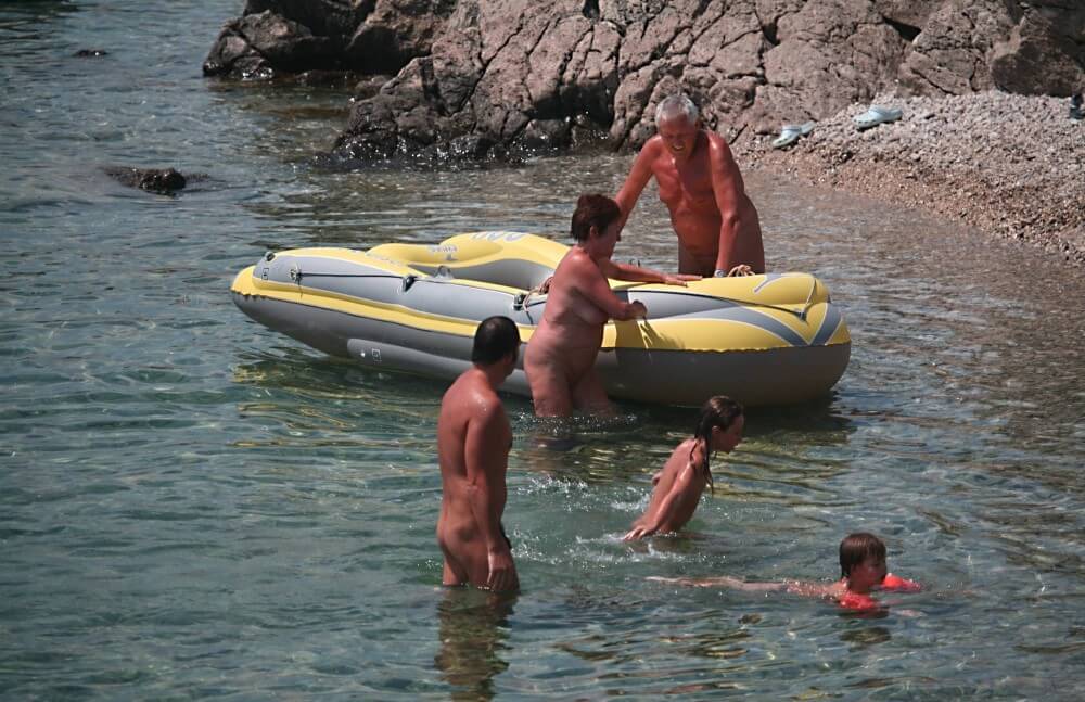 Lone Nudist in Yellow Boat photos - Nudity is perceived as a natural expression of life