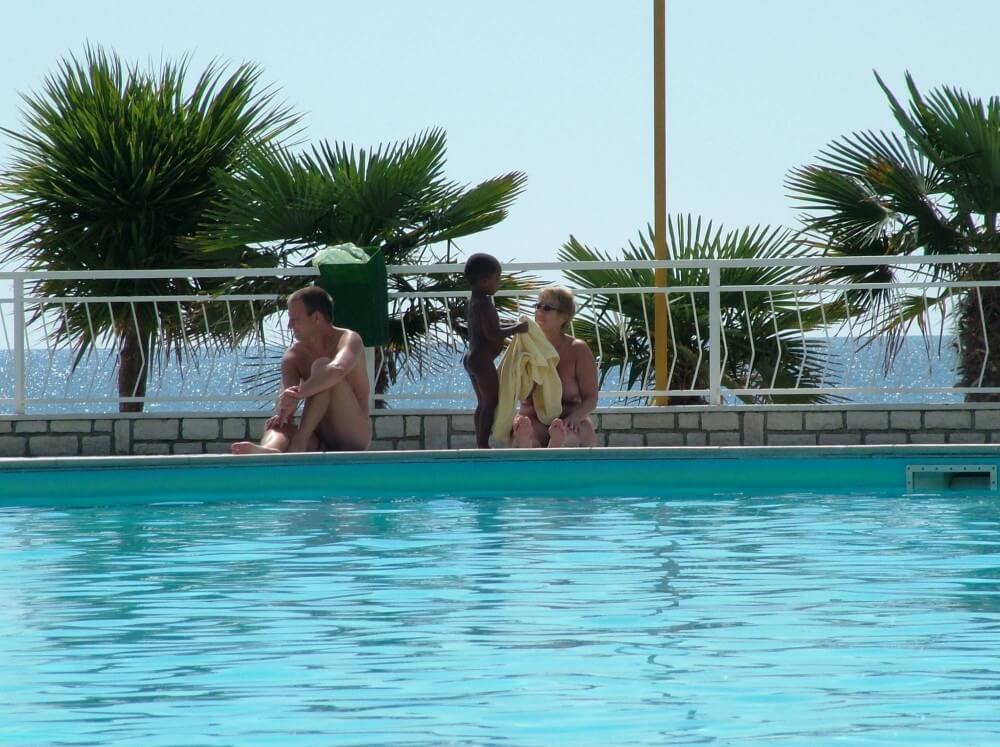 Photo of naturists in an outdoor pool - Core values of nudist clubs